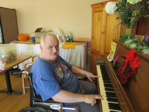 Tony M. playing the piano in the dining room