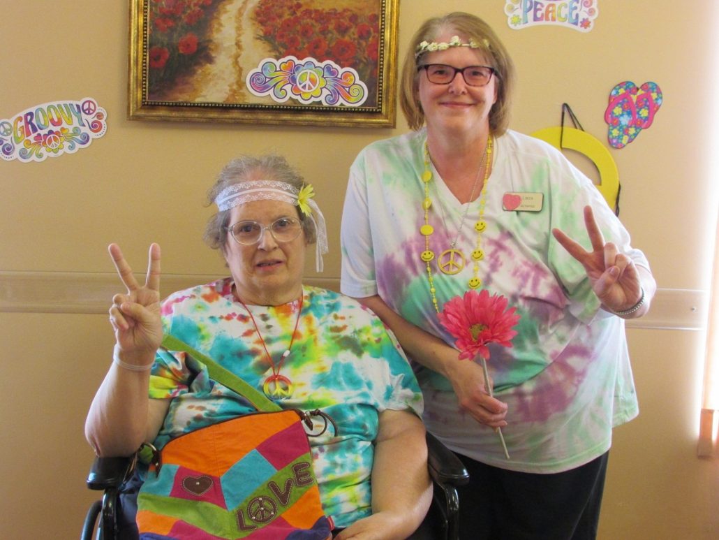 Lodger Linda and Linda from Activities giving a peace sign on National H…