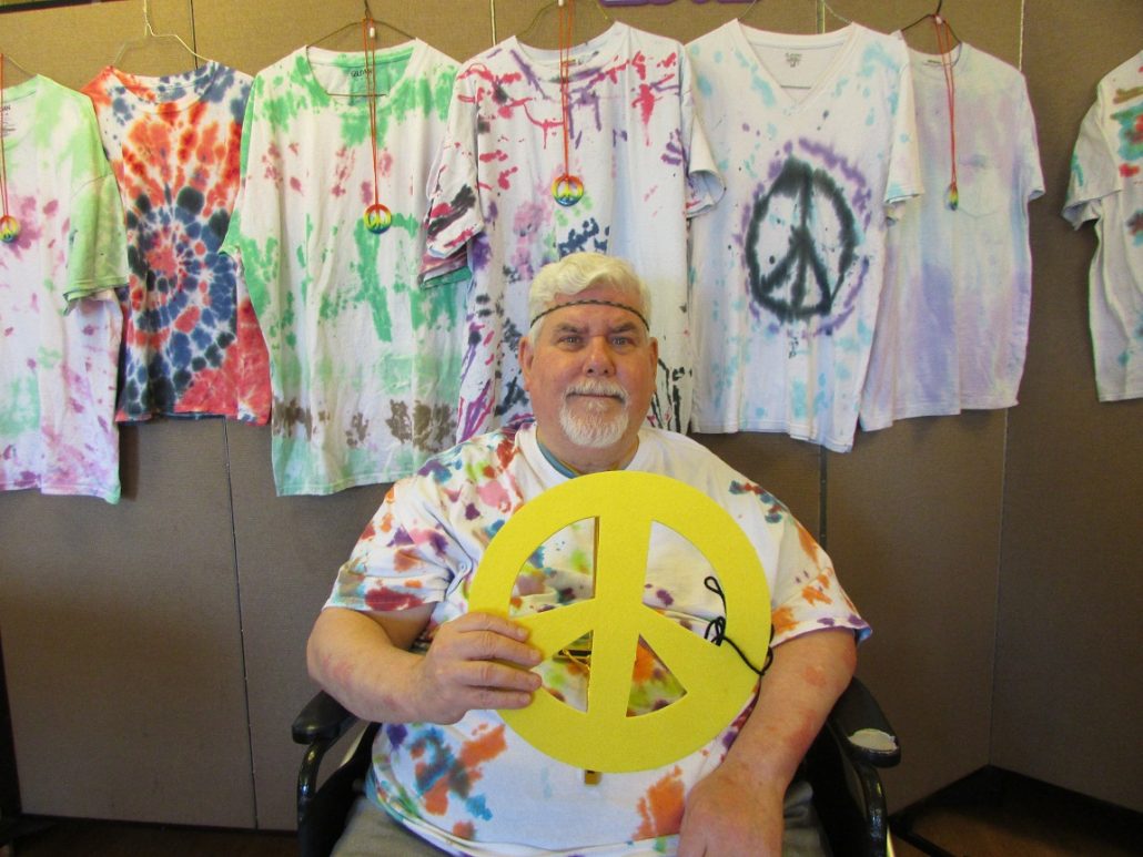 Lodger Tim holding a peace sign on National Hippie Day